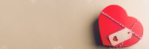 Preview: Red heart shaped gift box with tag placed on neutral background. Top view, flat lay, copy space