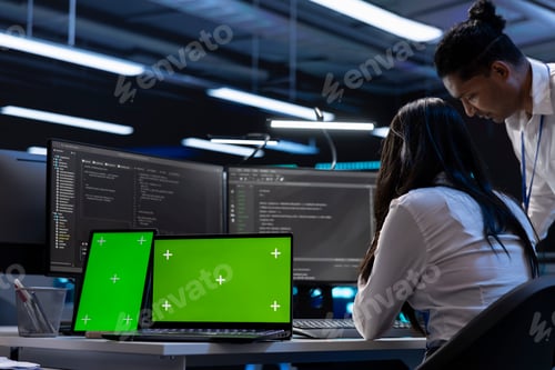 Preview: Employees in server room checking systems bottlenecks using chroma key devices