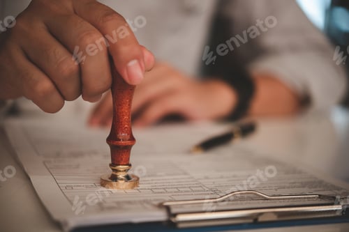 Preview: businessman hand stamping approved on certificate document contract in office.
