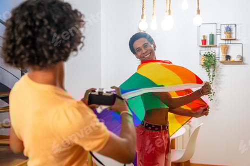Preview: Gay man waving lgbt rainbow flag while couple taking photos