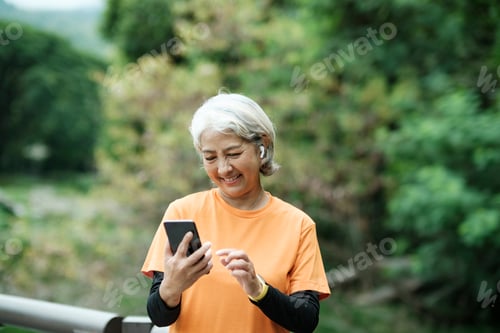 Preview: Senior Woman Smiling Using Mobile Phone Outdoors