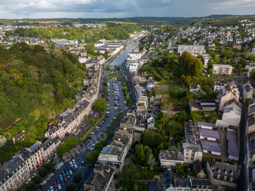 Preview: Aerial view of Dinan, France with historic buildings and lush greenery.