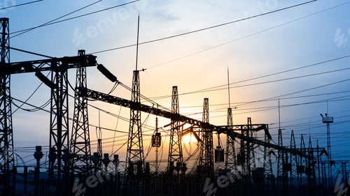 Preview: 4K time lapse. Silhouette of a network at transformer station in sunset, high voltage station