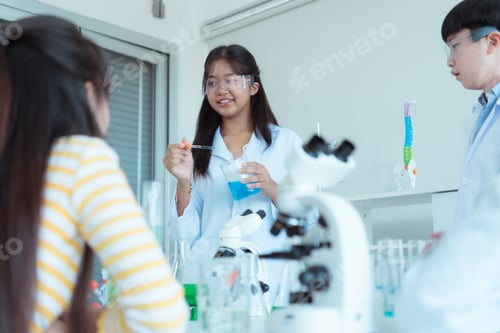 Preview: In the science classroom, an Asian child scientist experimenting with scientific formulas
