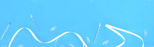Preview: Panoramic shot of white ribbon and candles on blue background