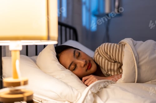 Preview: Asian beautiful woman lying down on bed in bedroom, dreaming at night.