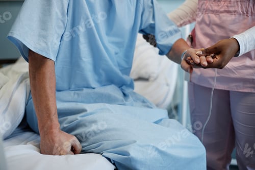 Preview: Hospital Worker Comforting Seated Patient Clasping Hands