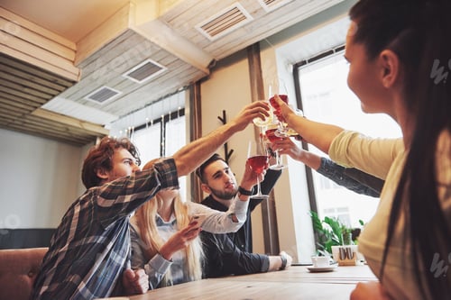 Preview: Hands of people with glasses of whiskey or wine, celebrating and toasting in honor of the wedding