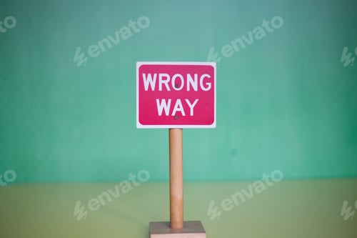 Preview: Closeup shot of a red "Wrong Way" sign on a blurred background