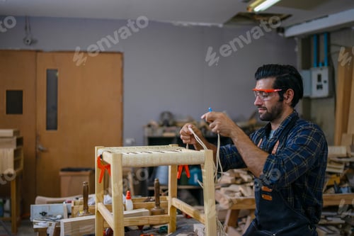 Preview: Carpenter is working at workshop.