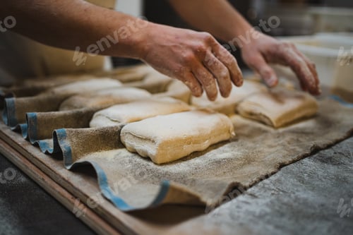 Preview: Baker man touching bread dough