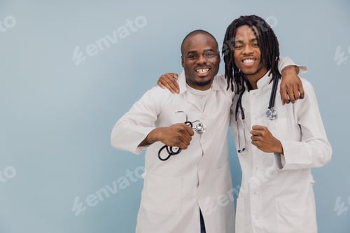Preview: Two Young African American Doctors Smiling with Stethoscope on Blue Background