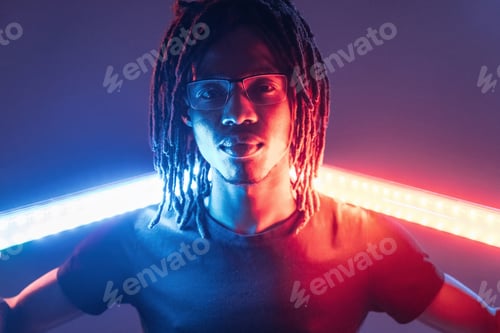Preview: Neon lighting equipment. African American guy is studio