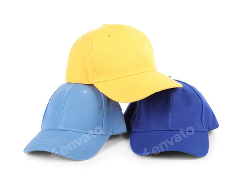 Preview: Blue and yellow baseball caps isolated on white. Mockup for design