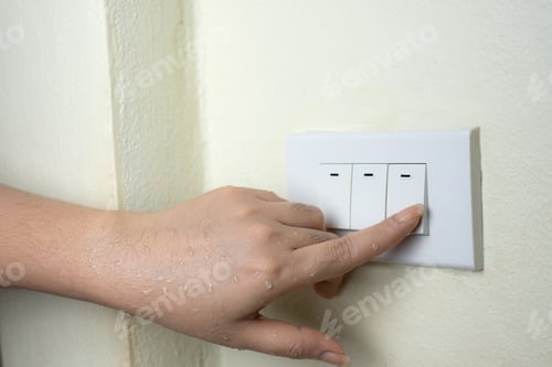Preview: Wet hand turn on lights electric switch on white wall background
