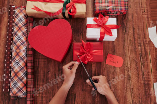 Preview: Man decorating Christmas presents