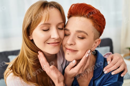 Preview: Young lesbian couple enjoying intimate moment in modern bedroom space