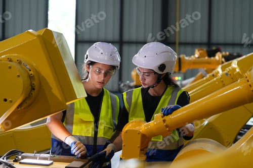 Preview: Robotics engineer working on maintenance of robotic arm in factory warehouse. Business technology.