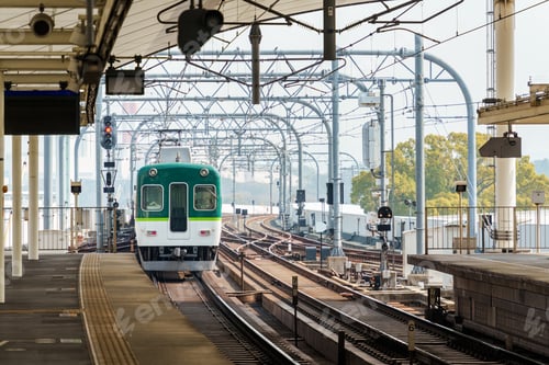 Preview: Electric railway train with metal structure and tracks arrival to station at Kyoto
