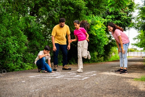 Preview: Indian family playing hopscotch or Tikkar Billa outdoors, spending joyful time in garden