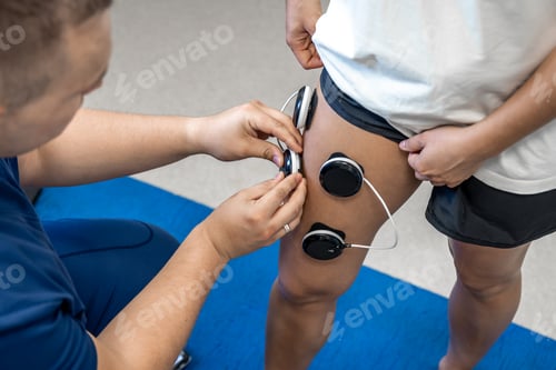 Preview: The procedure of myostimulation on the legs of a woman.