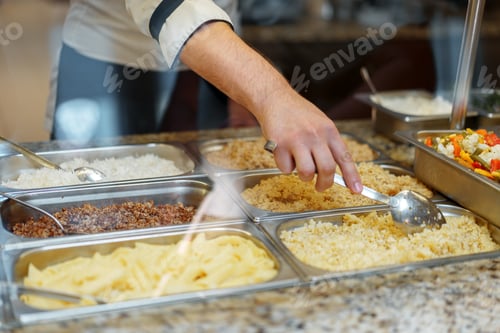 Preview: Chef Serving Freshly Cooked Dishes at a Restaurant Buffet During Lunchtime