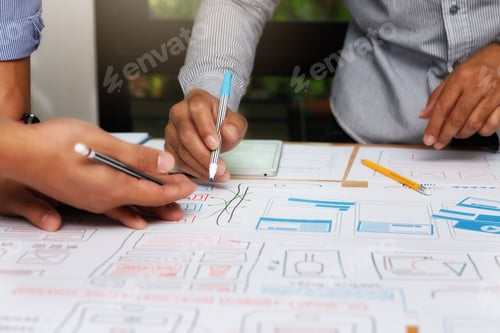Preview: UX or UI designers designing on their smartphone application layout prototype project.
