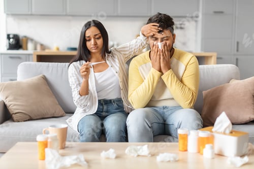 Preview: Concerned Indian Woman Comforting Man Feeling Unwell at Home