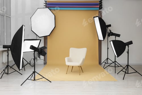 Preview: Interior of modern photo studio with armchair and professional lighting equipment