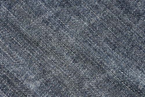 Preview: Detailed abstract texture of dark blue denim cloth. Background image of old used denim trousers