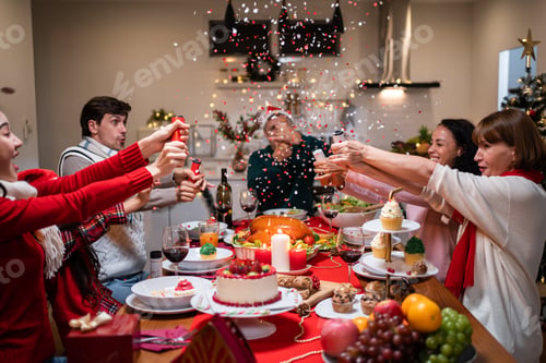 Preview: Multi-ethnic big family having dinner and celebrating Christmas party together on dining table.