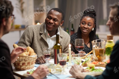 Preview: African couple sitting at holiday table