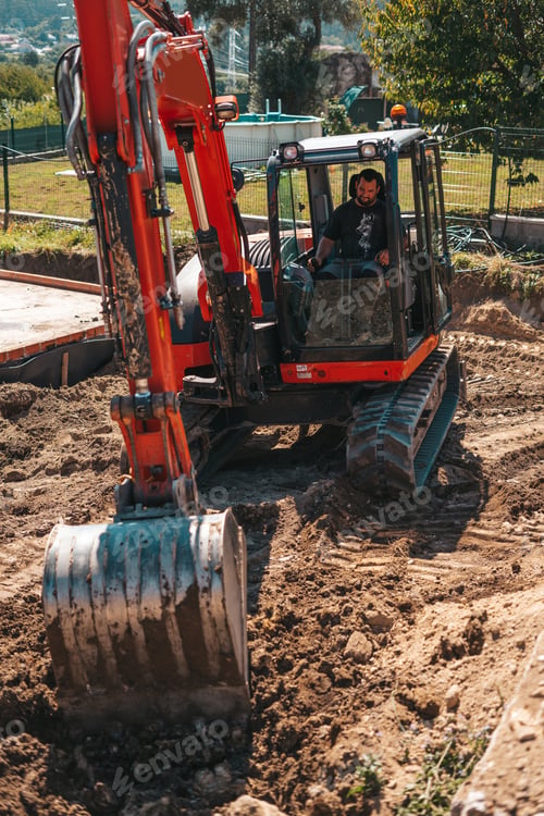 Preview: Worker driving an excavator on a construction site