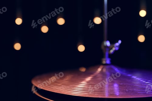 Preview: Drum hi-hat in the dark on a blurred background with lights.
