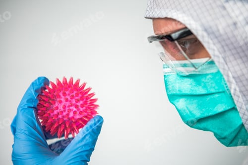 Preview: Scientist Holds Spiked Ball in Protective Medical Gear