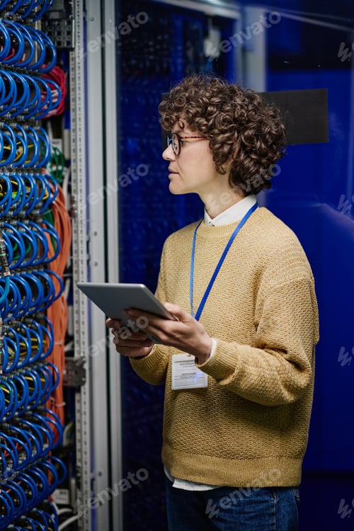 Preview: Network engineer working in server room