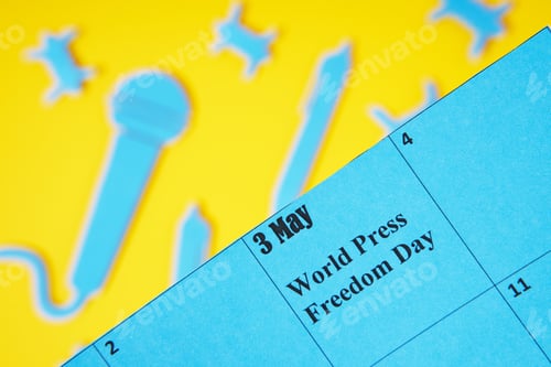 Preview: World press freedom day concept. 3 may. A black microphone and a pen made of paper, as a symbol of f