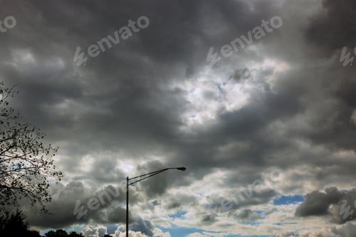Preview: Majestic thunderstorm clouds above a trees with road in dramatic stormy clouds