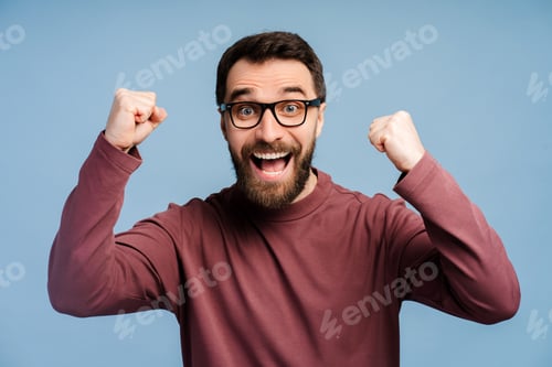 Preview: Overjoyed bearded man in glasses looking at camera, win money happy