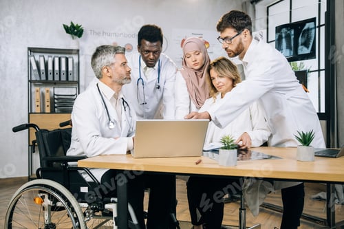 Preview: Group of multi ethnic medical workers using laptop at office