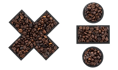 Preview: Multiplication and division sign made from coffee beans on a white background.