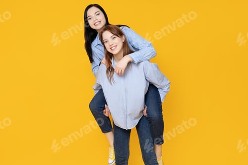 Preview: Young girls pose on a yellow background