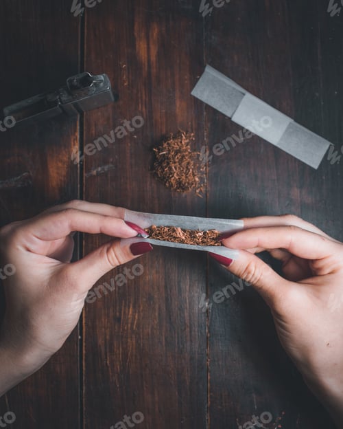 Preview: High angle shot of a female rolling a joint