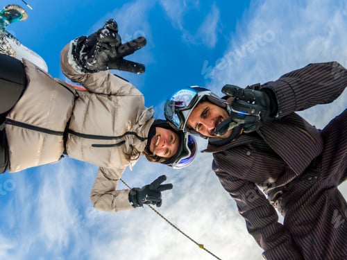Preview: Happy couple enjoying winter vacation while taking selfie
