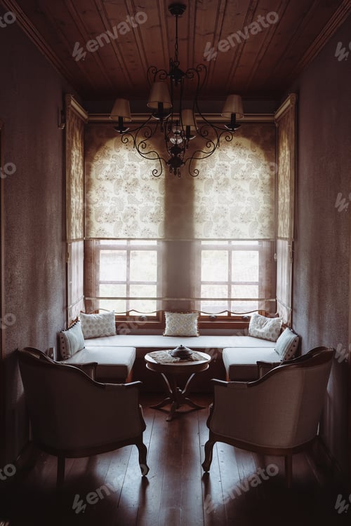 Preview: divan with several pillows in front of window