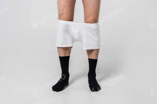 Preview: cropped shot of man in black socks with white underwear on grey backdrop