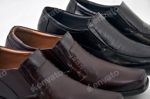 Preview: Horizontal shot of two pairs dark brown and black male shoes on a white background