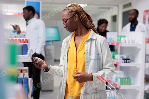 Preview: African american customer buying food supplements in drugstore