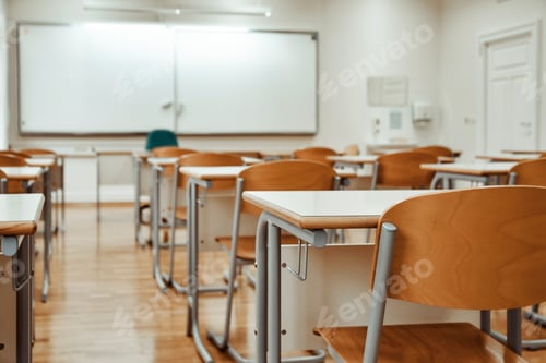Preview: Selective focus image of chairs and tables in empty school classroom.
