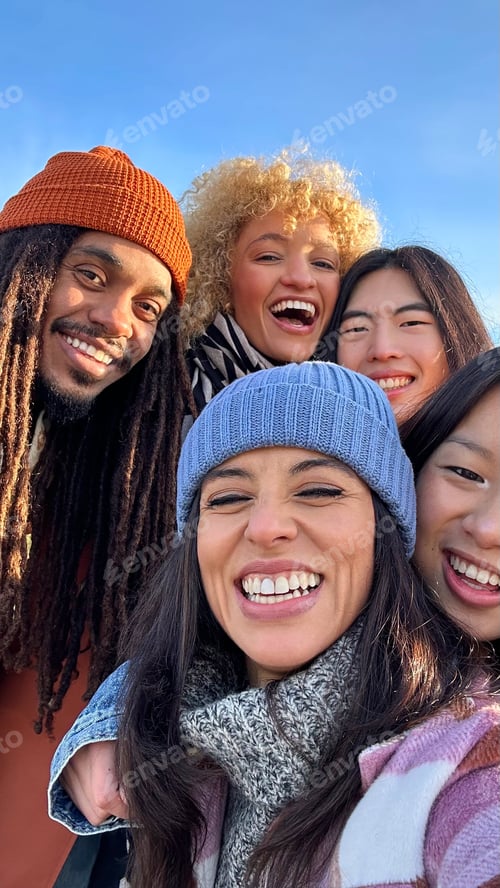 Preview: Young group of happy people taking selfie enjoying time together.